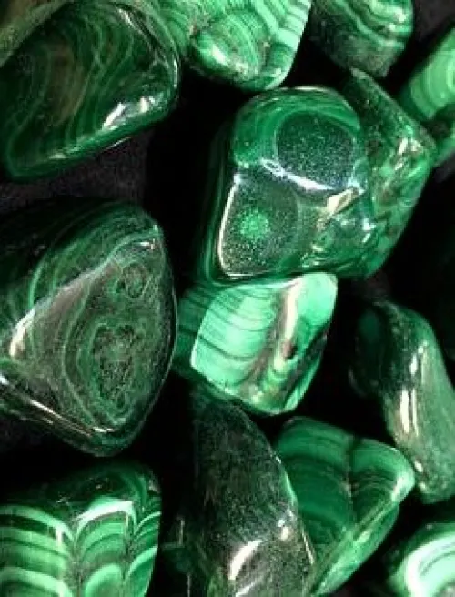 Close-up of malachite cleaning with microfiber cloth