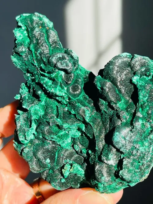 Malachite formation in oxidized copper ore showing green crust