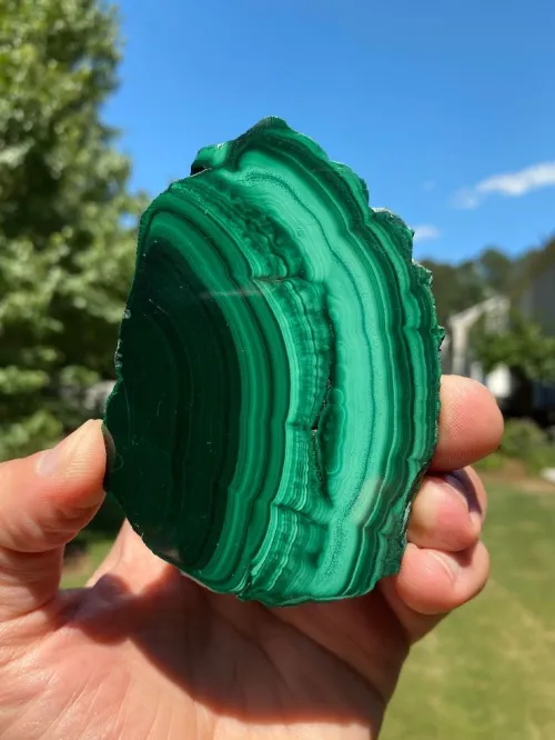 Malachite slice showing mineral banding transitions under light