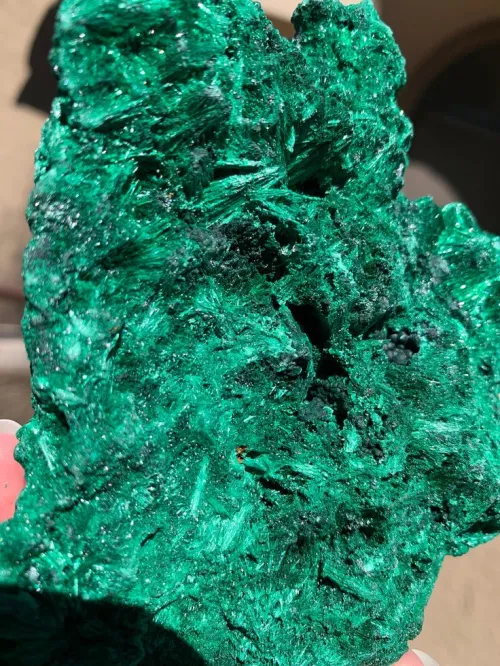 Polished malachite jewelry showing natural banding