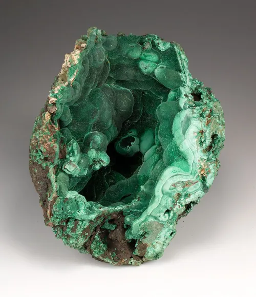 Raw malachite specimen showing crystal clusters and banding