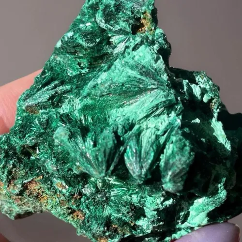 Related Image: Close-up of a malachite rock showing varying green shades and banding